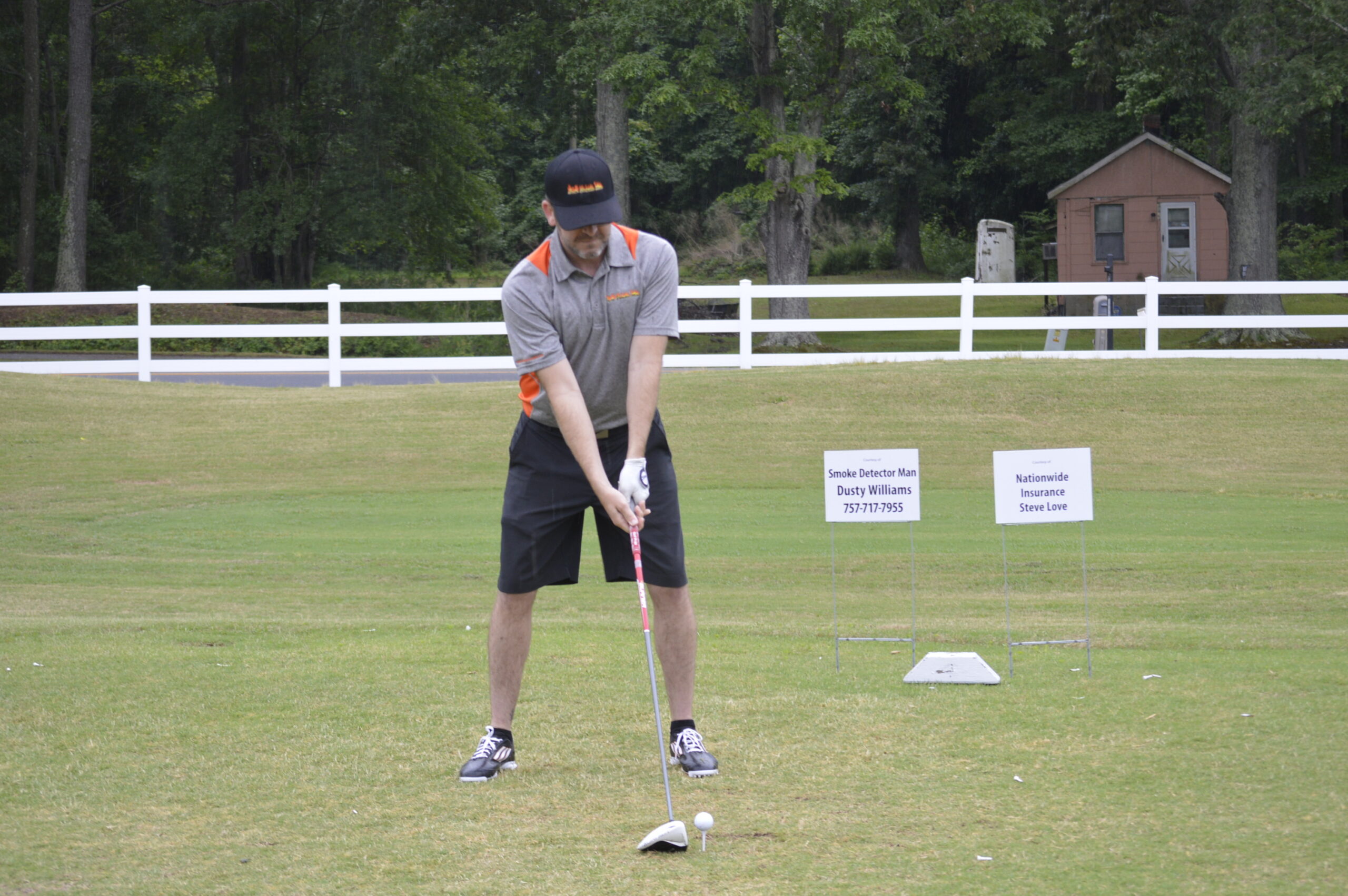 Golfer teeing off at the Golf Tournament