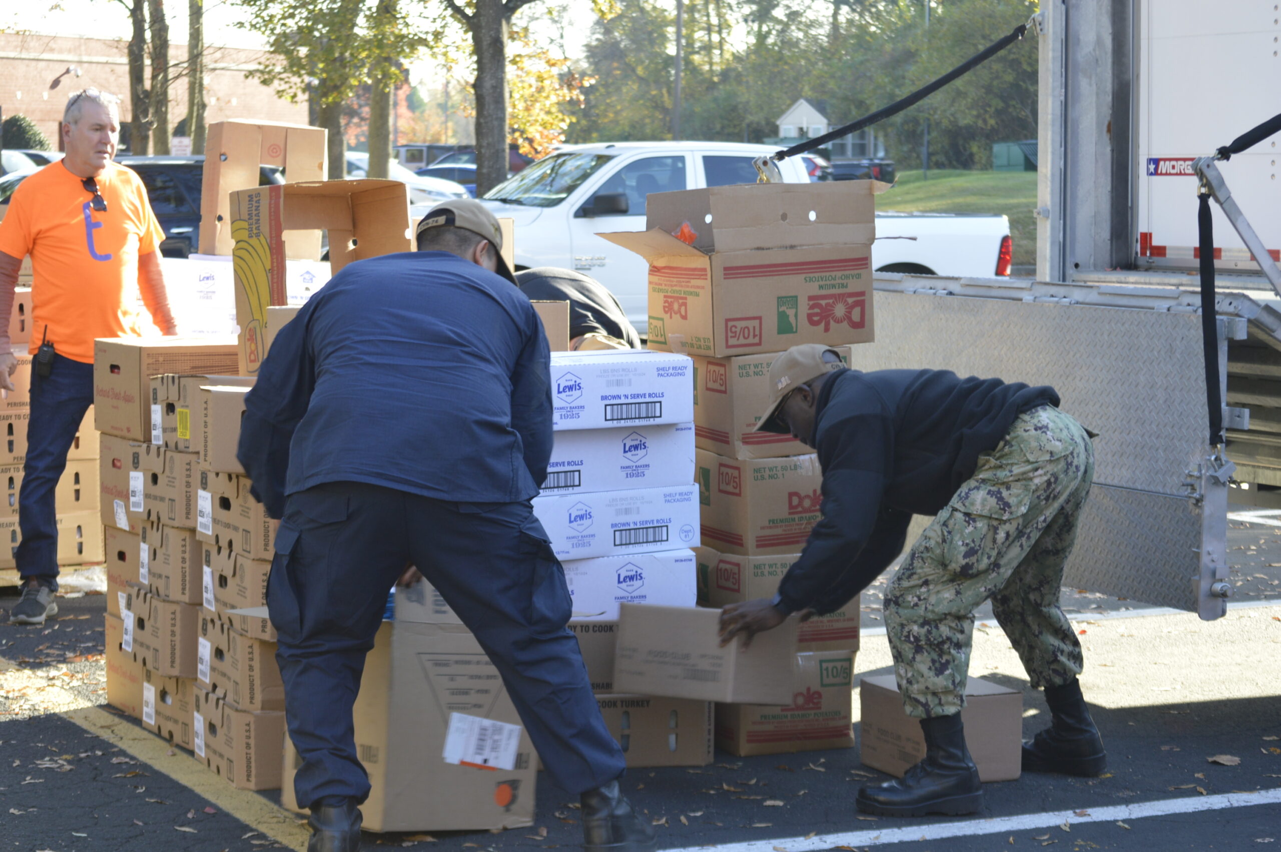 Volunteers unloading boxes of donated food