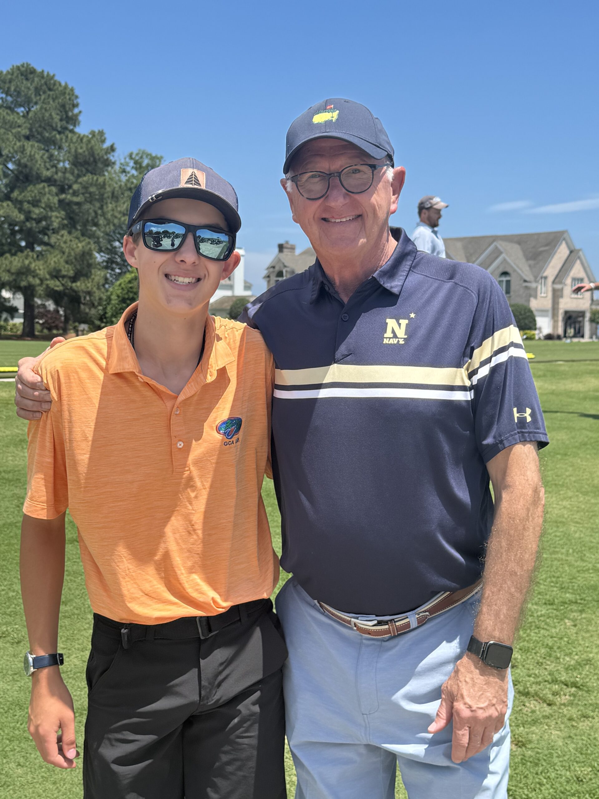 Two golfers posing on the course at the Golf Tournament
